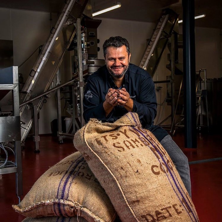 Photo de Vincent Guerlais avec des grains de cacao à la chocolaterie